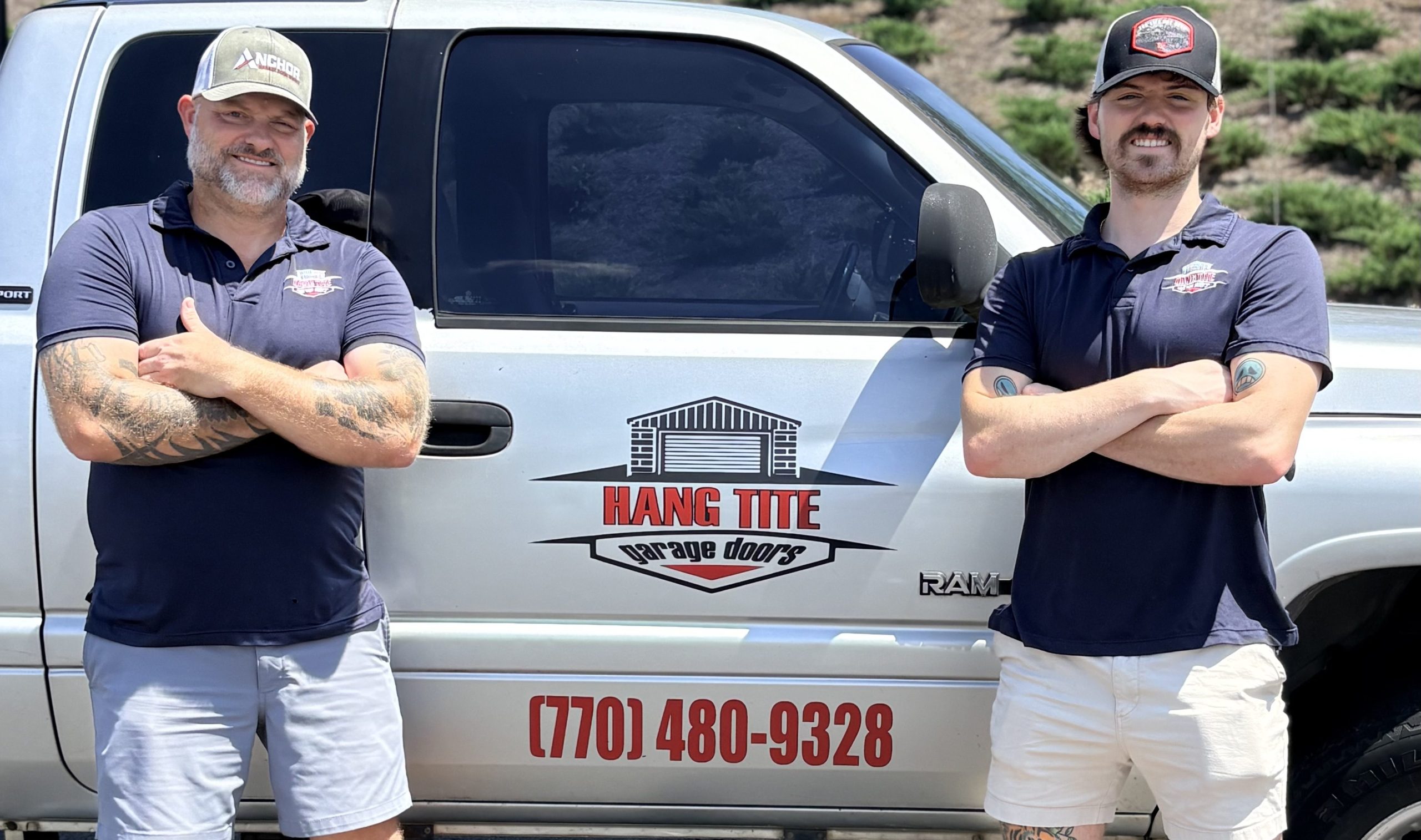 Hang Tite Garage Doors Owner and Technician in front of company truck